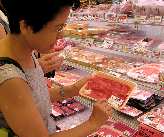 Japanese shopper at the meat counter. The country will not invoke higher tariffs on U.S. beef on Aug. 1. (DTN file photo by Marcia Zarley Taylor)