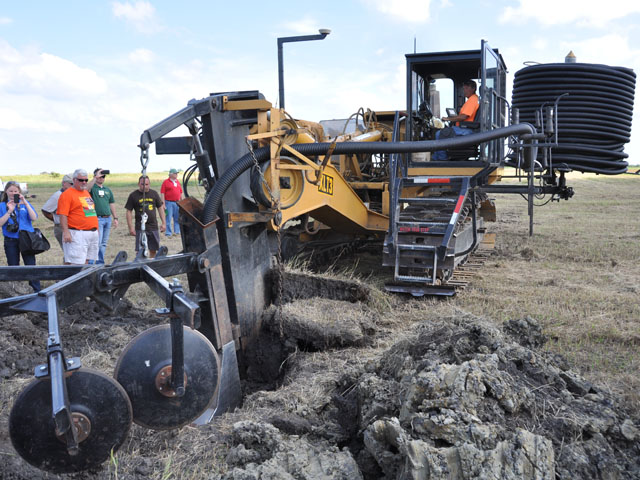 Workers demonstrate tiling a field in this file photo. There are concerns that the waters of the U.S. rule will discourage farmers from certain conservation practices. (DTN file photo by Chris Clayton)