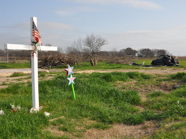 In late February, the land around the backside of the former West, Texas, fertilizer plant still showed evidence of the severity of the blast from a year earlier. Memorial markers help honor the 15 people who were killed, most of whom were firefighters. (DTN photo by Greg Horstmeier)