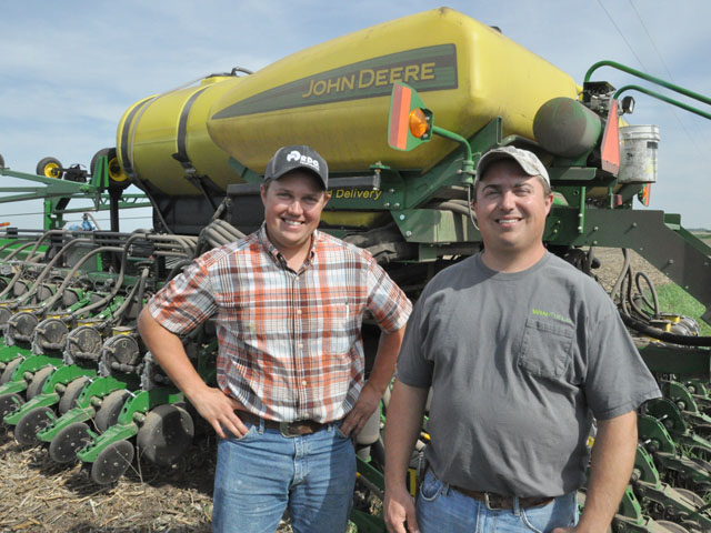 Jason (left) and Aaron Frerichs of Wilmot, S.D., stand next to their John Deere planter as they finish planting soybeans May 30. Thanks to drier field conditions, the brothers were done two weeks earlier than last year. (DTN photo by Russ Quinn)