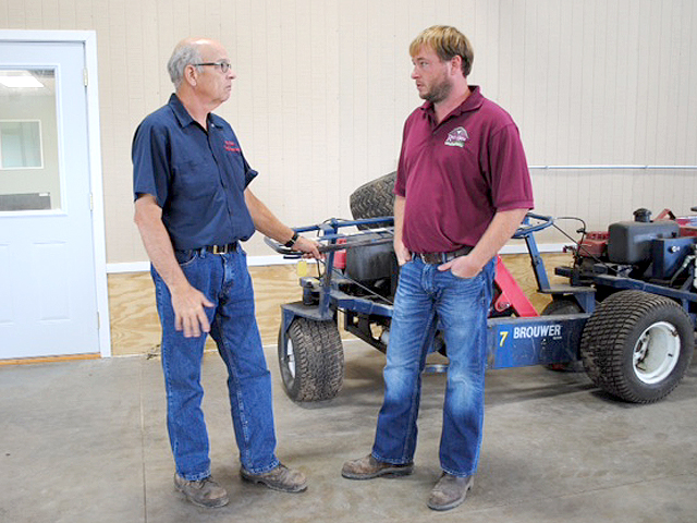 Gordon Millar (shown here with his father David on left) recently boosted cash reserves by refinancing farm equipment he had bought for cash over the last 12-18 months. (DTN photo by Marcia Zarley Taylor)
