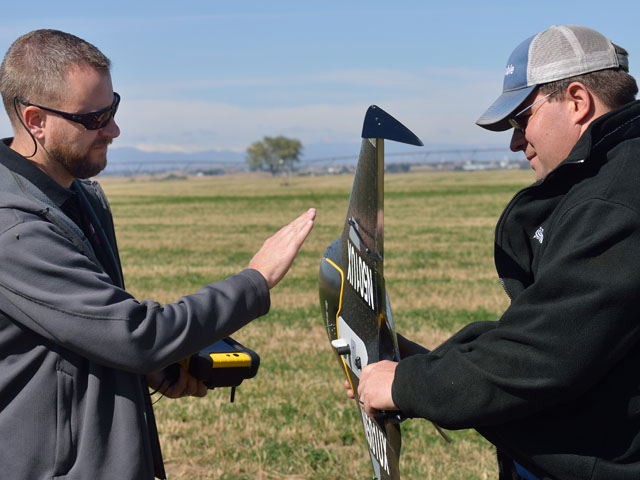 Without a licensed pilot such as Jason Downing (left), Trimble&#039;s training specialist Wade Stewart could not fly the company&#039;s UX5, an unmanned aerial system. (DTN/The Progressive Farmer photo by Jim Patrico)