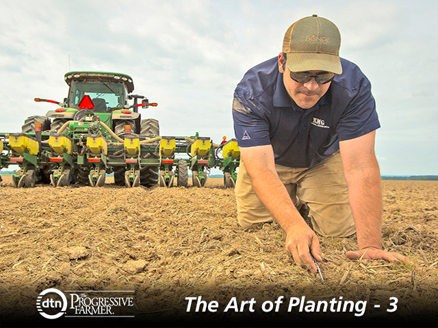 Derek Haigwood checks soybean seed placement behind a planter. (Progressive Farmer photo by Lance Murphey)