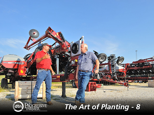 Roger Schmidt and his customer Dennis Meech (right) discuss new planters on the dealership lot. (Progressive Farmer photo by Jim Patrico)