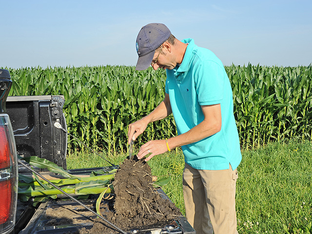 Adam Watson wants corn roots that run deep. That&#039;s why he routinely digs to see what&#039;s happening below ground. (Progressive Farmer photo by Pamela Smith)