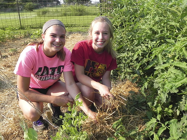 Abby Lindsey (left) and Logan Stufflebeam helped weed, mulch and harvest fresh produce in the Nevada, Iowa FFA garden this past summer. The high school sophomores attended the 2015 National FFA Convention in Louisville, Kentucky, last week along with advisor Kevin Cooper and several other chapter members. (Photo courtesy of Kevin Cooper/Nevada FFA Chapter)