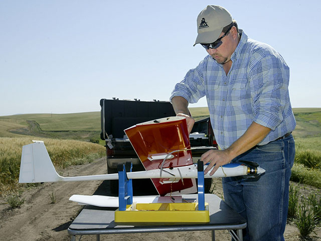 Wheat farmer and UAV expert Robert Blair sets up a plane for flight. He said fixed-wing vehicles -- not hover craft -- will be the choice of professionals in the ag industry. (Photo courtesy Robert Blair)