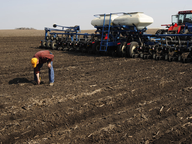 Planting corn before soils are warm and dry enough is tempting as May approaches, but the practice can encourage disease, compaction, and poor emergence. (DTN photo by Bob Elbert)